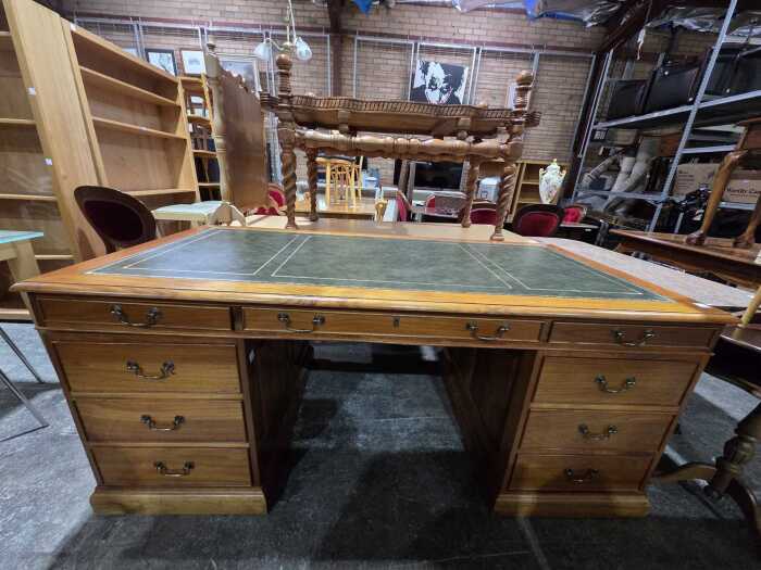 Twin pedestal desk with green leather inset top