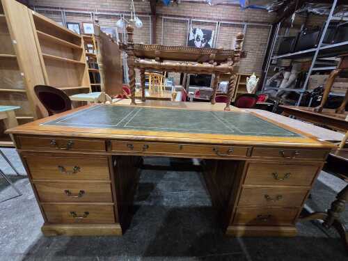 Twin pedestal desk with green leather inset top