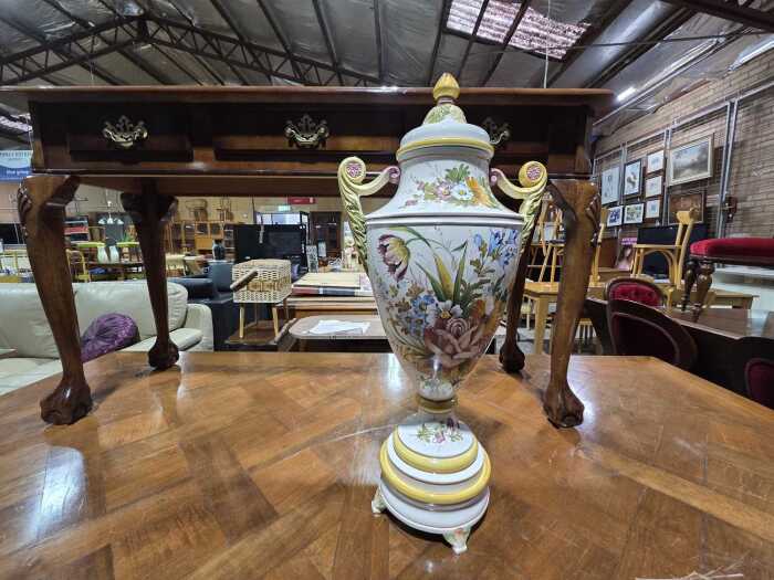 Ceramic twin-handled lidded urn with vibrant floral motif