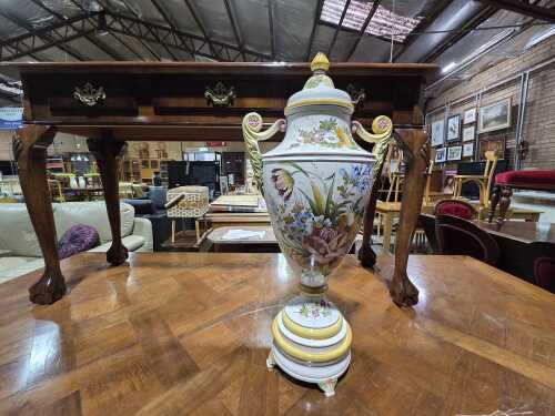Ceramic twin-handled lidded urn with vibrant floral motif