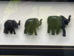 'The Migration, twelve graduated carved timber elephants in shadow box - 3