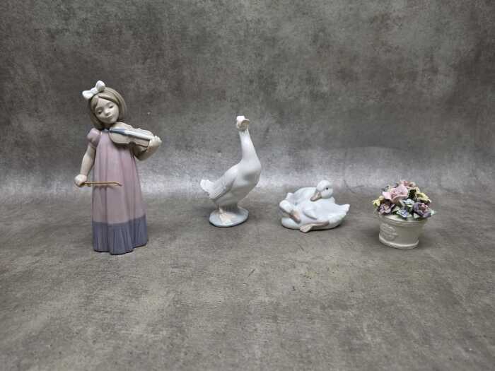 Three Nao by Lladro porcelain figures, plus a floral pot