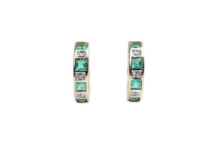 A pair of emerald and diamond hoops in 9 carat yellow gold