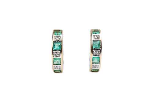 A pair of emerald and diamond hoops in 9 carat yellow gold