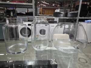 Three clear glass floor vases in various shapes