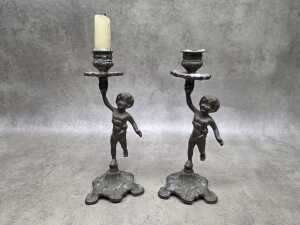 Pair of cast brass figural candlesticks