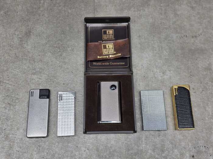 Five cigarette lighters, including Juvena