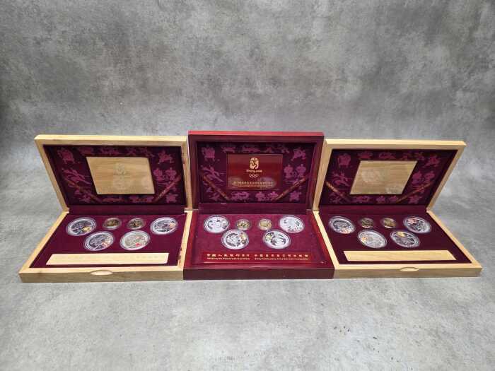 Three Beijing 2008 Olympics gold tone and silver tone souvenir medallion sets