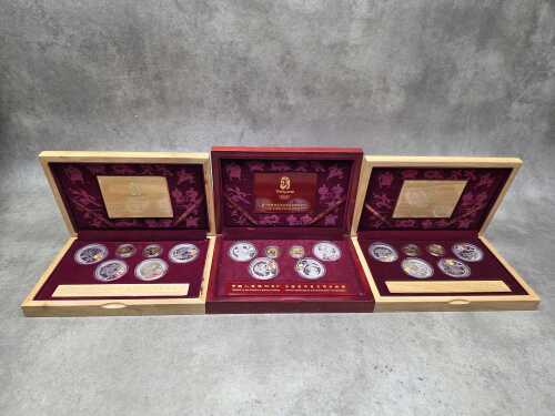 Three Beijing 2008 Olympics gold tone and silver tone souvenir medallion sets