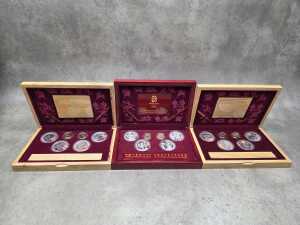 Three Beijing 2008 Olympics gold tone and silver tone souvenir medallion sets