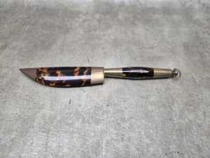 Decorative dagger and sheath with polished tortoiseshell and brass fittings