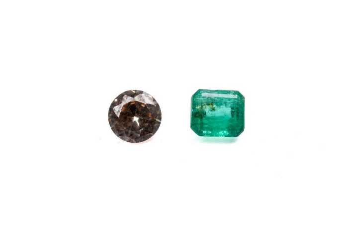 A round morganite and emerald cut emerald