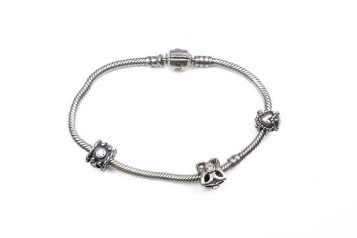 A pandora bracelet with three retired charms