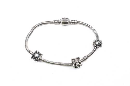 A pandora bracelet with three retired charms