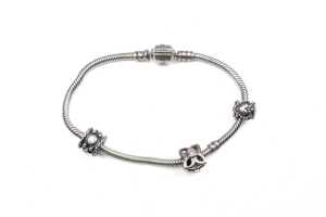 A pandora bracelet with three retired charms