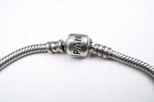 A pandora bracelet with three retired charms - 2