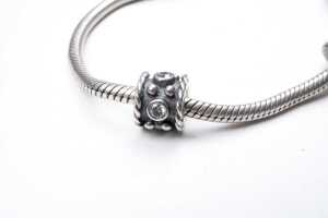 A pandora bracelet with three retired charms - 3