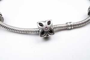 A pandora bracelet with three retired charms - 4