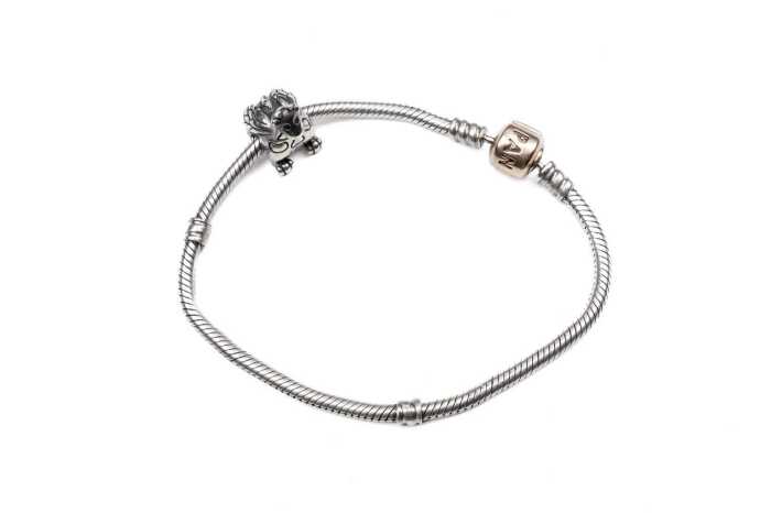 A Pandora bracelet with rare retired Winniper charm in sterling silver.