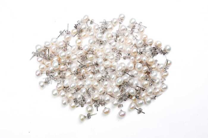 Large collection of freshwater pearl stud earrings in sterling silver.