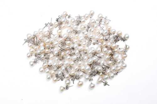 Large collection of freshwater pearl stud earrings in sterling silver.