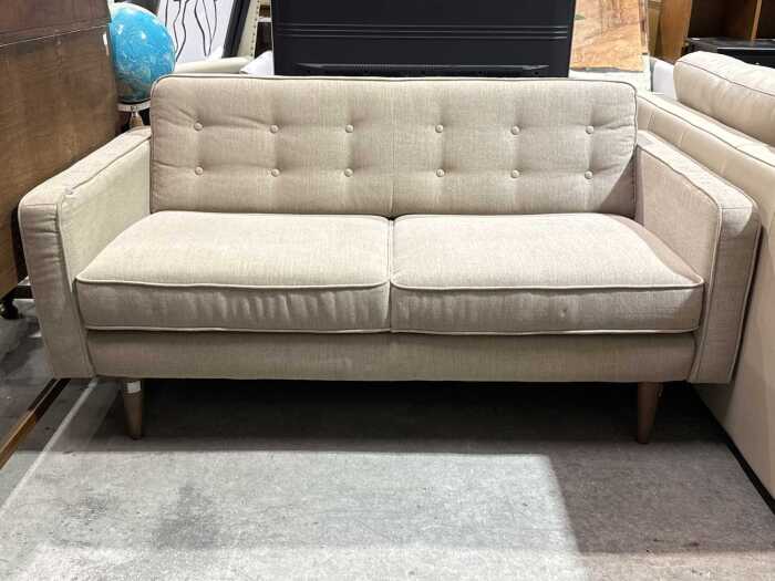 Contemporary beige upholstered two-seat sofa