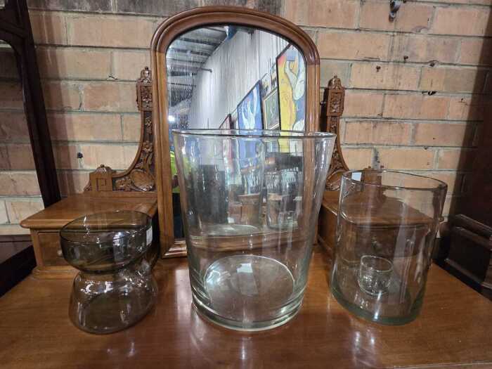 Three large glass vases in various shapes.