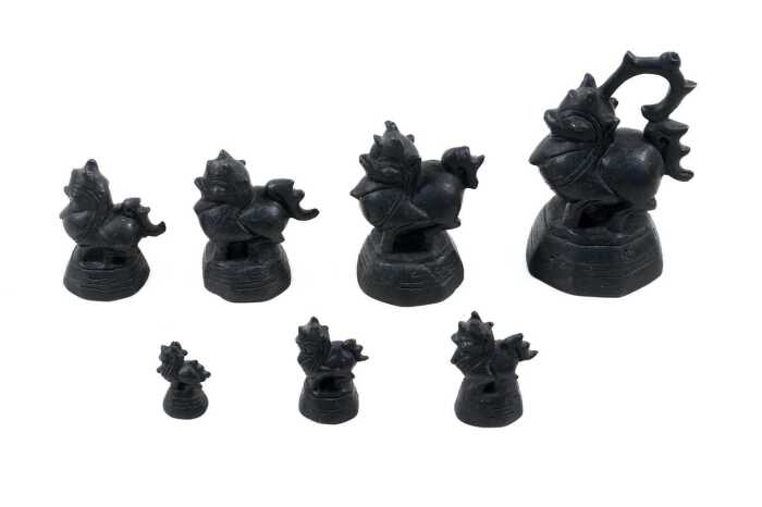 Antique Burmese set of seven bronze opium weights surmounted by dragon figures