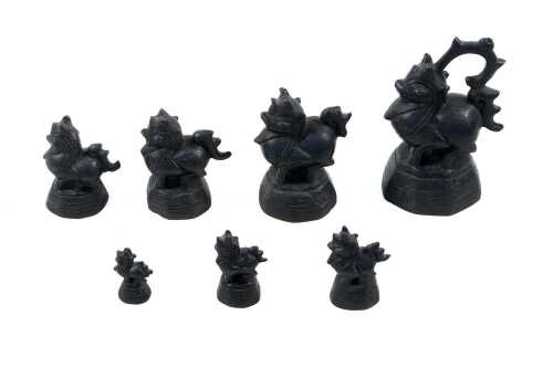 Antique Burmese set of seven bronze opium weights surmounted by dragon figures