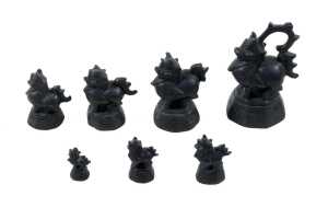Antique Burmese set of seven bronze opium weights surmounted by dragon figures