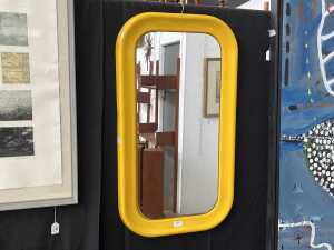 Mid-century space-age yellow tubular plastic wall mirror with rounded corners
