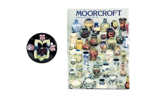 Moorcroft 'Violets' ceramic pin dish together with Moorcroft Revised Edition 1897-1993 book