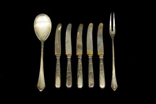 Two pieces of German 800 silver flatware, and five mounted knives