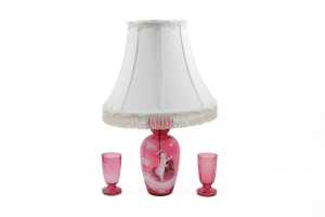 Mary Gregory style cranberry glass lamped vase, together with two glasses