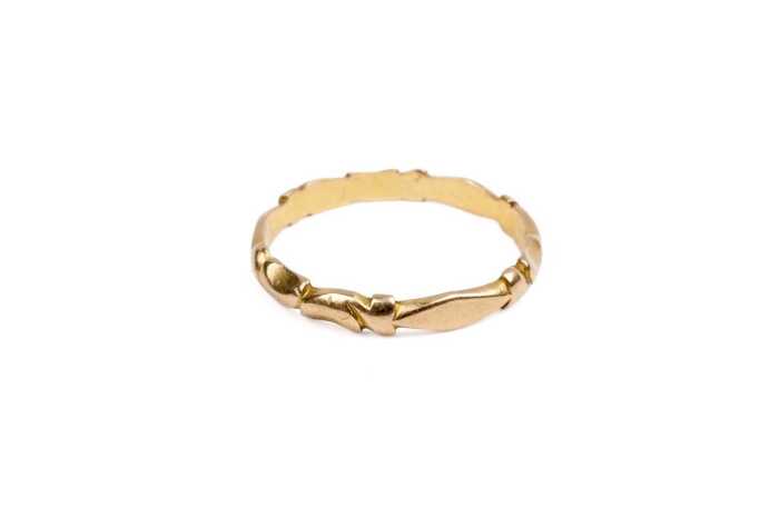 A carved band in 22 carat yellow gold