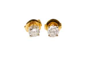 A pair of diamond stud earrings in 9 carat yellow gold