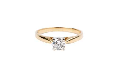 A diamond solitaire ring in 14 carat yellow gold