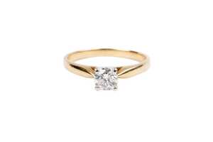 A diamond solitaire ring in 14 carat yellow gold