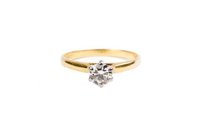 A diamond solitaire ring in 18ct yellow and white gold