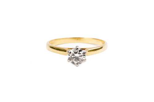 A diamond solitaire ring in 18ct yellow and white gold