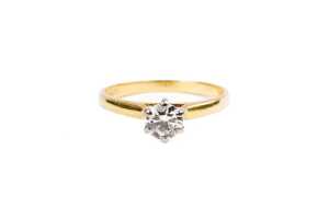 A diamond solitaire ring in 18ct yellow and white gold