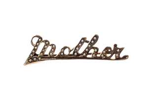 An antique seed pearl "Mother" brooch in 9 carat yellow gold