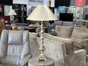 Faux antique silver-coloured table lamp on square acanthus leaf base.
