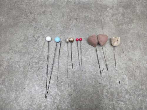 Eleven vintage hat pins