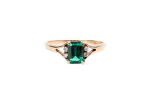 A synthetic emerald and diamond ring in 9 carat yellow gold