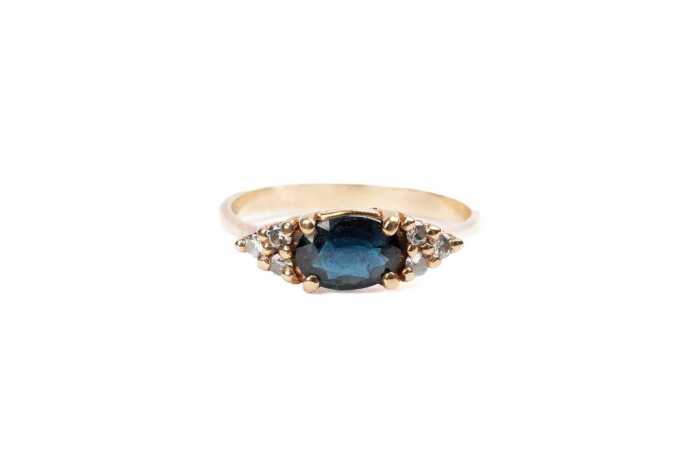 A sapphire and diamond ring in 9 carat yellow gold
