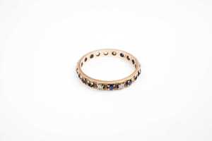 A sapphire and diamond band in 9 carat yellow gold