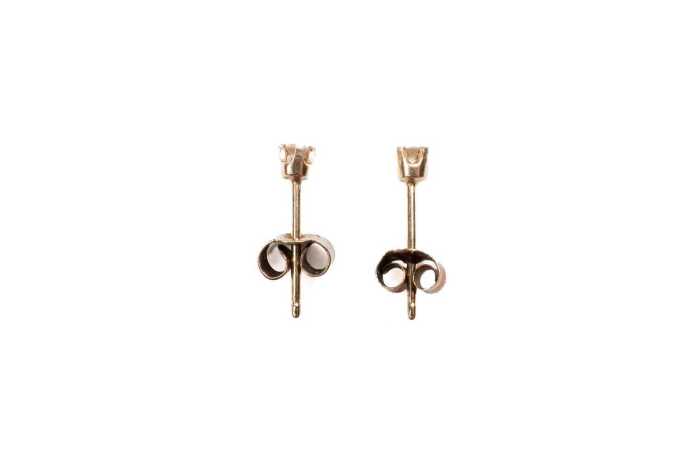 A pair of diamond stud earrings in 9 carat yellow gold