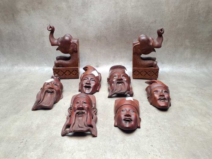 Asian carved timber wall masks and elephant bookends