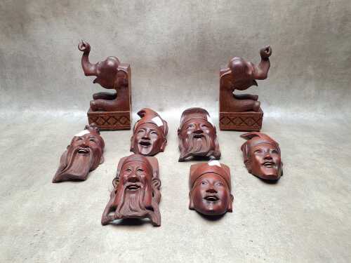 Asian carved timber wall masks and elephant bookends
